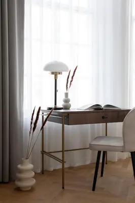 a desk with a lamp and a chair next to a window at Bob W Oosterpark in Amsterdam