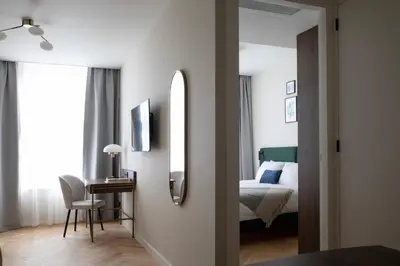 a bedroom with a bed and a desk with a mirror at Bob W Oosterpark in Amsterdam