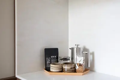 a shelf with a book and other items on it at Bob W Oosterpark in Amsterdam