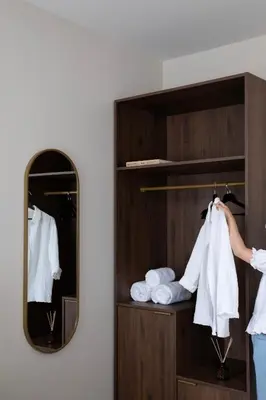 a woman standing in a closet with a mirror at Bob W Oosterpark in Amsterdam