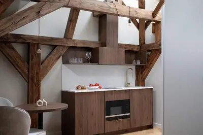a kitchen with wooden ceilings and a table at Bob W Oosterpark in Amsterdam