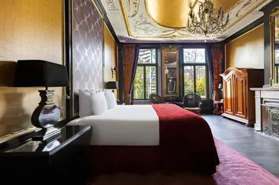 a hotel room with a bed and a fireplace at The Toren Amsterdam, by The Pavilions in Amsterdam