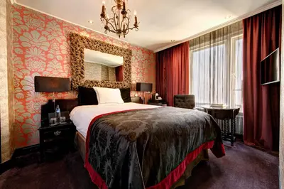 a hotel room with a bed and a mirror at The Toren Amsterdam, by The Pavilions in Amsterdam
