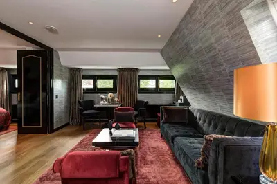 a living room with a couch and a table at The Toren Amsterdam, by The Pavilions in Amsterdam