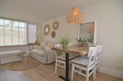 a living room with a table and a couch at Casa Feliz in Egmond aan Zee