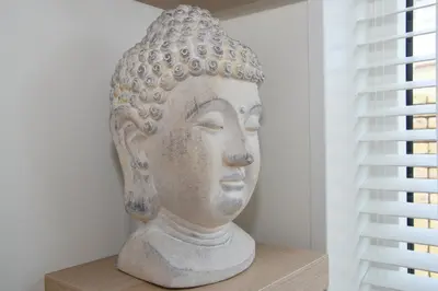 a statue sitting on a shelf next to a window at Casa Feliz in Egmond aan Zee