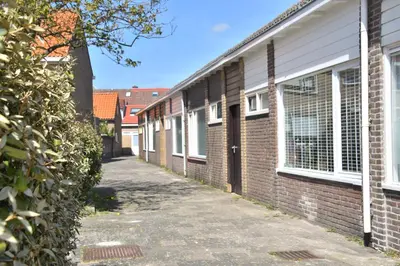 a row of brick houses on a street at Casa Feliz in Egmond aan Zee