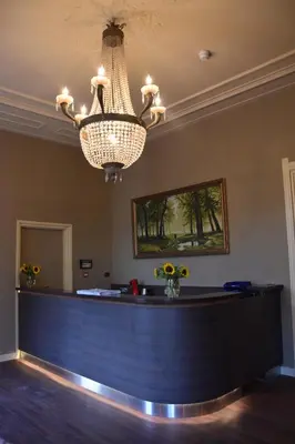 a bar at a hotel with a chandelier at OZO Hotels Armada Amsterdam in Amsterdam