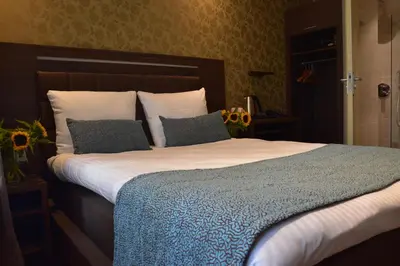 a bedroom with a large bed with two pillows at OZO Hotels Armada Amsterdam in Amsterdam