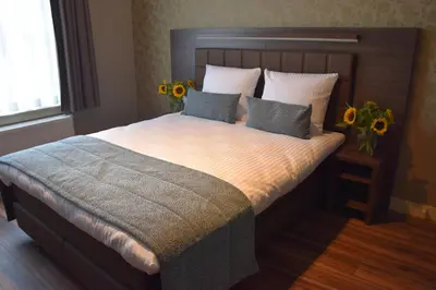 a bedroom with a large bed with sunflowers on it at OZO Hotels Armada Amsterdam in Amsterdam