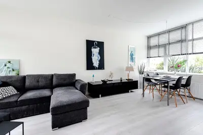 a living room with a couch and a table at Sea Shell apartment in Zandvoort