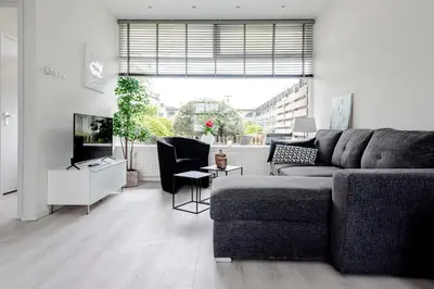 a living room with a couch and a tv at Sea Shell apartment in Zandvoort
