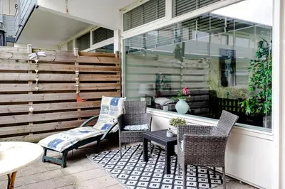 a patio with chairs and a table and a window at Sea Shell apartment in Zandvoort