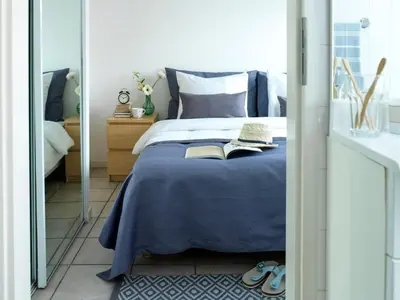 a bedroom with a bed with two books on it at Amsterdam / Loosdrecht Rien van den Broeke Village in Loosdrecht