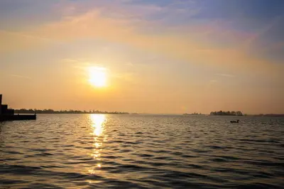 a sunset over a large body of water at Amsterdam / Loosdrecht Rien van den Broeke Village in Loosdrecht