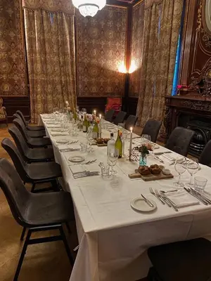 a long table in a room with chairs and a table with glasses at Landgoed Oud Poelgeest - Leiden in Oegstgeest