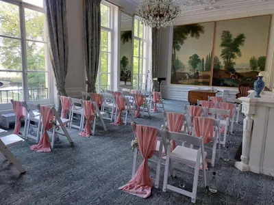 a room with chairs and tables and a chandelier at Landgoed Oud Poelgeest - Leiden in Oegstgeest