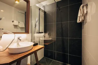 a bathroom with a sink and a shower at Landgoed Oud Poelgeest - Leiden in Oegstgeest