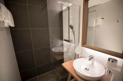 a bathroom with a sink and a shower at Landgoed Oud Poelgeest - Leiden in Oegstgeest