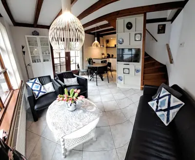 a living room with couches and a table at Onder de Boomen in Bergen
