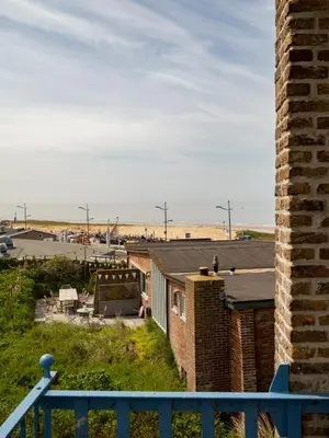 a view of the beach from the roof of a house at Vernieuwd Zeezicht Villa Zee Luxe in Bergen aan Zee