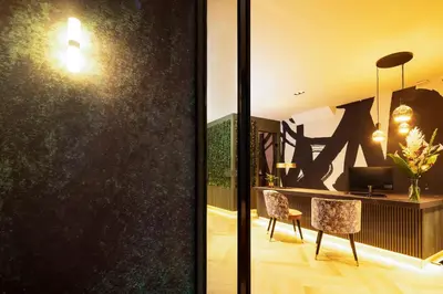 a living room with a desk and a chair at Huygens Place Amsterdam in Amsterdam