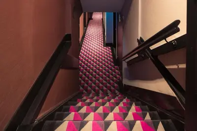 a stairway with pink and black flooring in a building at Huygens Place Amsterdam in Amsterdam