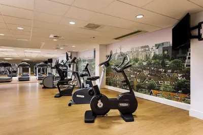 a gym with several exercise bikes in a room at NH Amsterdam Noord in Amsterdam
