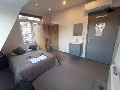 a bedroom with a large bed and a bathroom at Hotel-Chao NL 24 hours open in Utrecht