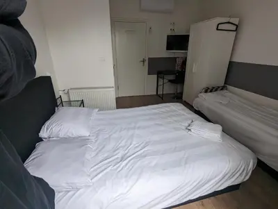a large white bed in a room with at Hotel-Chao NL 24 hours open in Utrecht