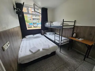 a bedroom with two bunk beds and a window at Hotel-Chao NL 24 hours open in Utrecht