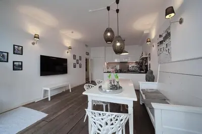 a white living room with a sink and a tv at Hotel Zeespiegel in Zandvoort