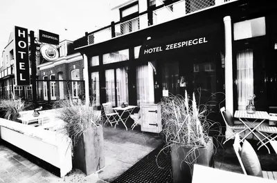 a black and white photo of a street with a hotelership at Hotel Zeespiegel in Zandvoort