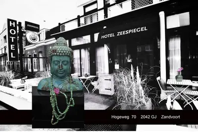 a statue of a buddha in front of a store at Hotel Zeespiegel in Zandvoort