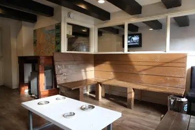 a wooden bench in a room with a table at Amsterdam Downtown Hotel Canal View in Amsterdam