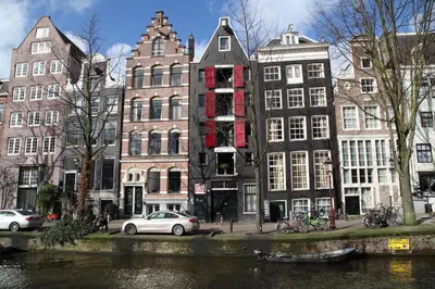 a group of buildings on the side of a river at Amsterdam Downtown Hotel Canal View in Amsterdam
