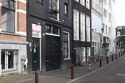 a building with a black door on a city street at Amsterdam Downtown Hotel Canal View in Amsterdam