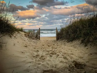 a sandy path leading to the ocean on a beach at Ocean BreezeApartment: WakeUp 2 Sound of the Waves in Zandvoort