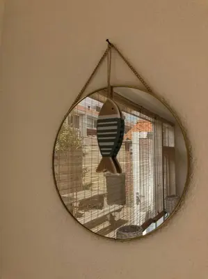 a mirror hanging on a wall with a window at Have a nice stay! - Voilà! - beach at 500m- free parking in Noordwijk aan Zee