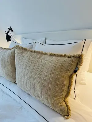 a pillow sitting on top of a bed at Duinstudio Bergen in Bergen