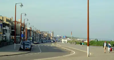 a street with cars parked on the side of the road at Nicolette Apartments in Katwijk