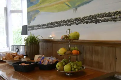 a table with bowls of fruit on top of it at Hotel Molengroet in Noord-Scharwoude