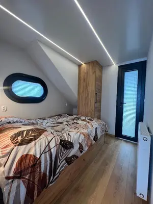 a bedroom with a bed and a window at NEW - Little Asia - Stunning Boathouse on a lake Near Amsterdam with Sauna in Vinkeveen