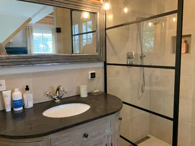 a bathroom with a sink and a shower at Lovely warm Country home in Breukeleveen