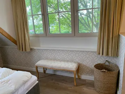 a room with a bench and two windows at Lovely warm Country home in Breukeleveen