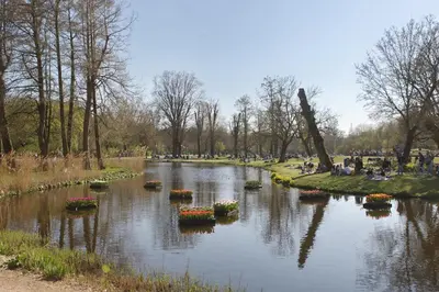 a river in a park with flowers in the water at Aadam Wilhelmina Hotel in Amsterdam