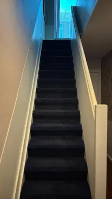 a staircase in a building with black stairs at Aadam Wilhelmina Hotel in Amsterdam