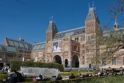 a large brick building with people sitting in front of it at Aadam Wilhelmina Hotel in Amsterdam