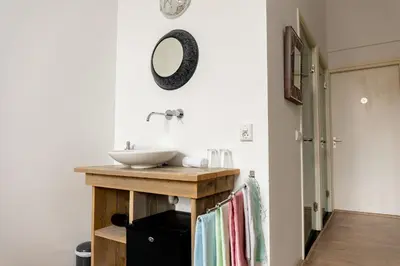 a bathroom with a sink and a mirror on the wall at 1001 Nights Boutique Hotel in Haarlem
