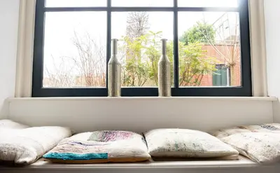 a row of pillows sitting on a window sill at 1001 Nights Boutique Hotel in Haarlem